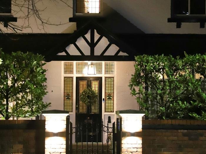 A lit front entrance of a house at night
